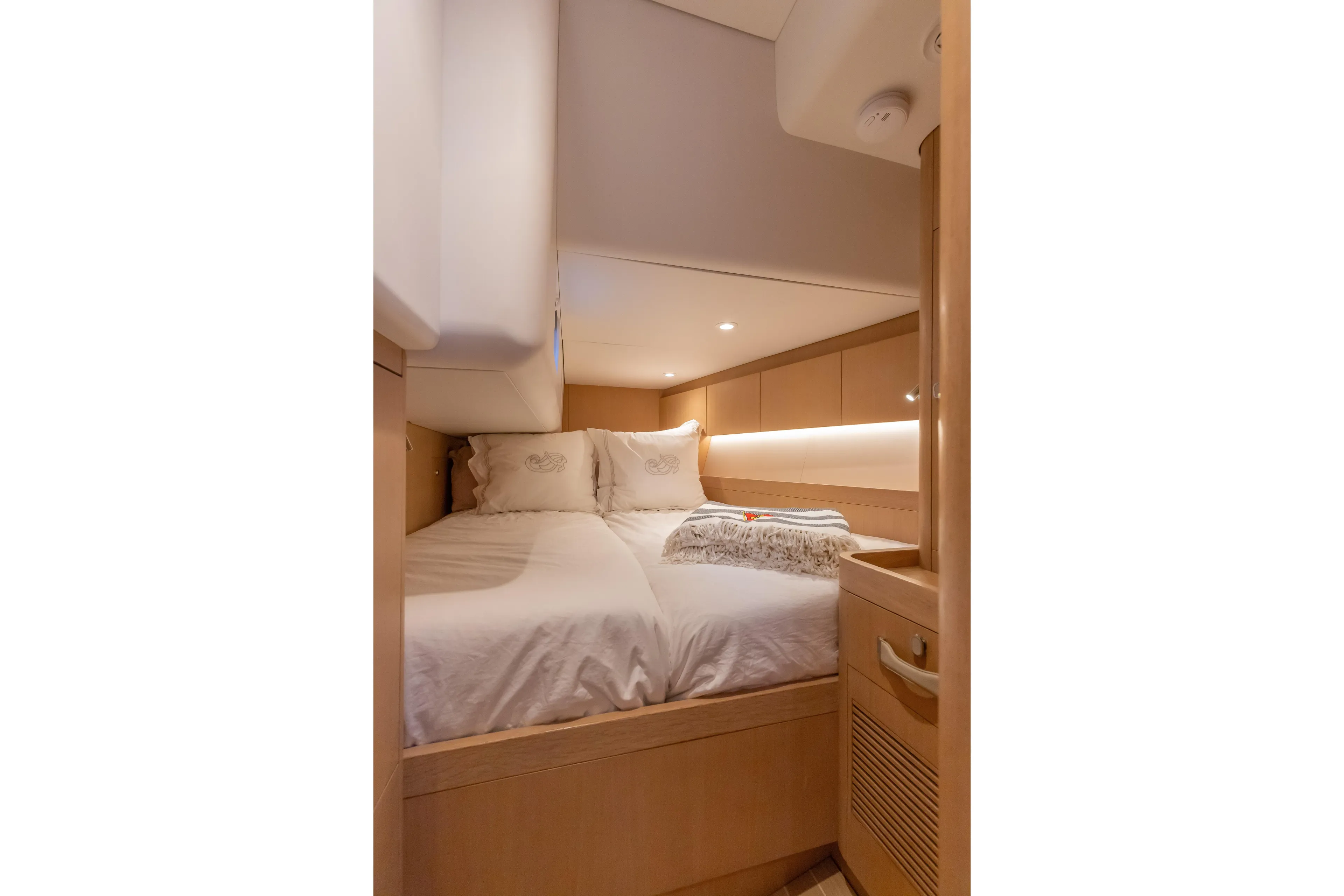 Nehalennia Yacht Photos Pics Luxurious cabin interior of 2018 Nautor Swan 54 yacht, featuring cozy bedding and elegant wood finishes.