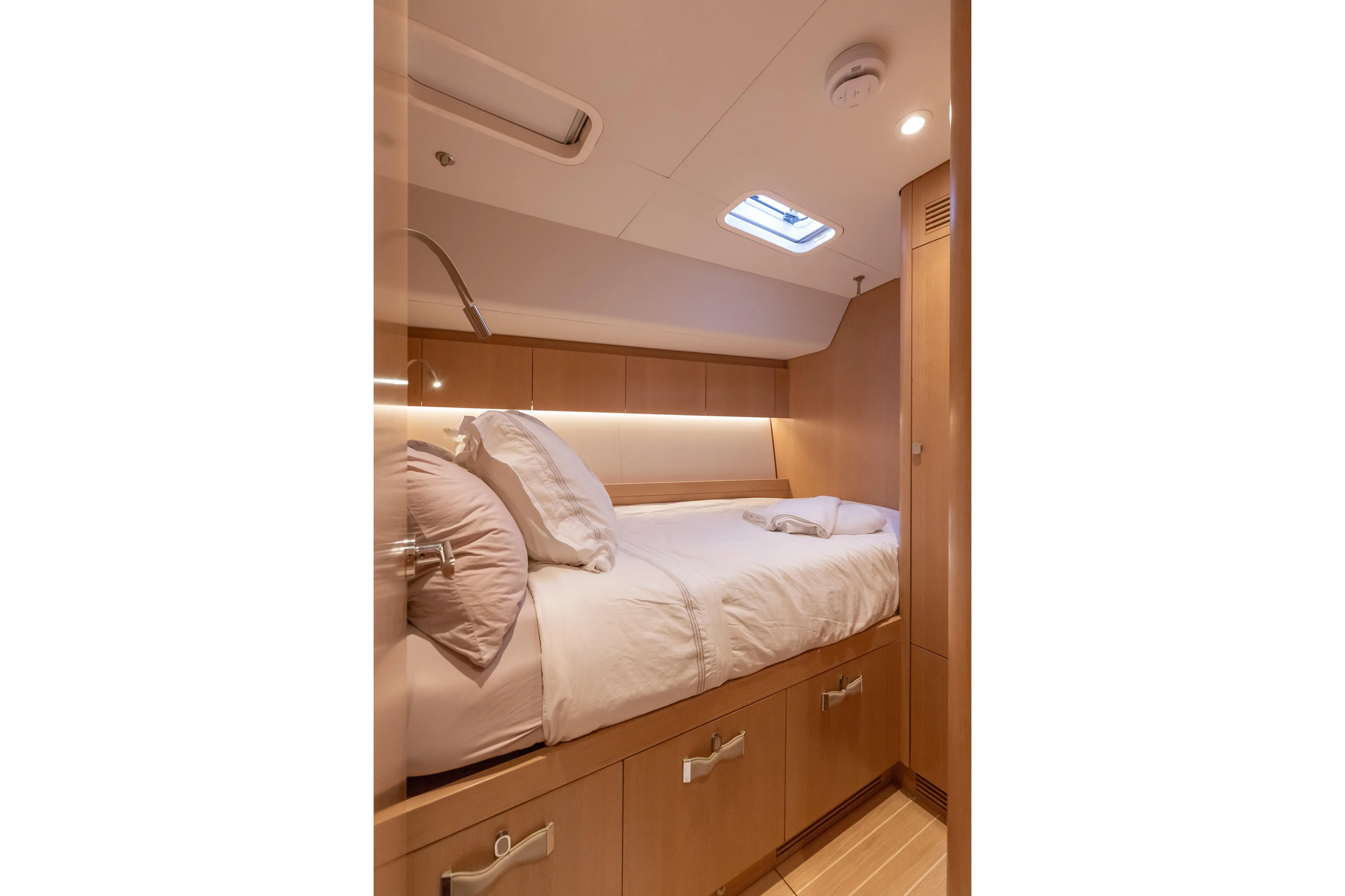 Nehalennia Yacht Photos Pics Luxurious cabin interior of 2018 Nautor Swan 54 yacht with cozy bed and modern lighting.