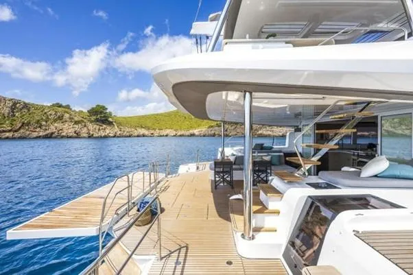  Yacht Photos Pics Luxurious 2025 Lagoon 60 yacht on serene blue waters, featuring spacious deck and modern design.