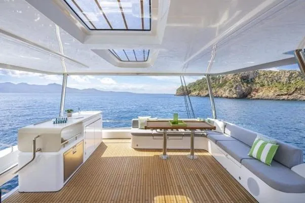  Yacht Photos Pics Luxurious Lagoon 60 yacht interior, 2025 model, featuring elegant seating and ocean views.
