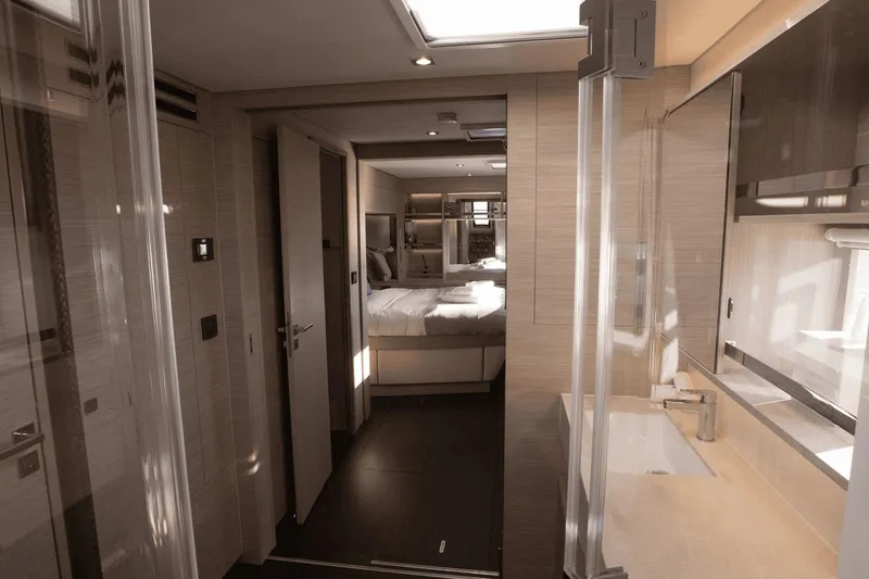  Yacht Photos Pics Luxurious interior of 2025 Lagoon 60 yacht featuring modern bedroom and bathroom design.