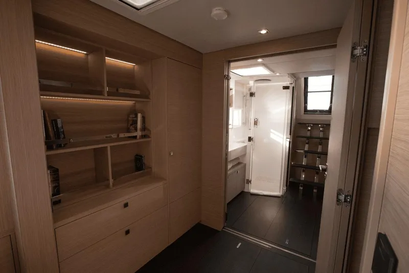  Yacht Photos Pics Luxurious interior of 2025 Lagoon 60 yacht with modern wood finish and elegant bathroom.