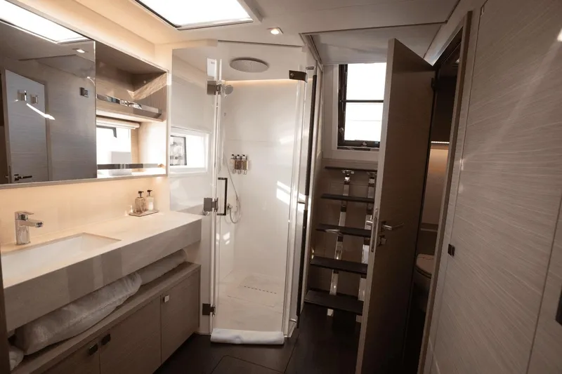  Yacht Photos Pics Luxurious bathroom interior of 2025 Lagoon 60 yacht, featuring modern fixtures and elegant design.