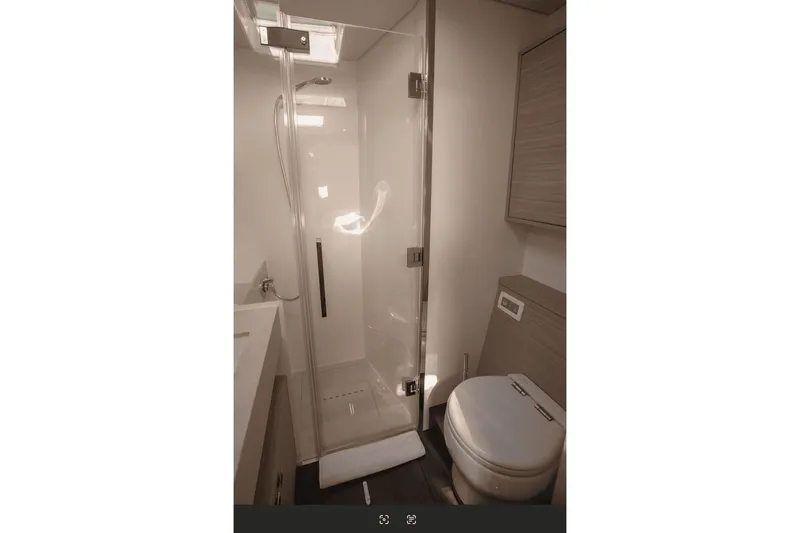  Yacht Photos Pics Modern bathroom in 2025 Lagoon 60 yacht with glass shower and sleek fixtures.