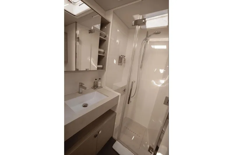  Yacht Photos Pics Modern bathroom in 2025 Lagoon 60 yacht with sleek shower and vanity.