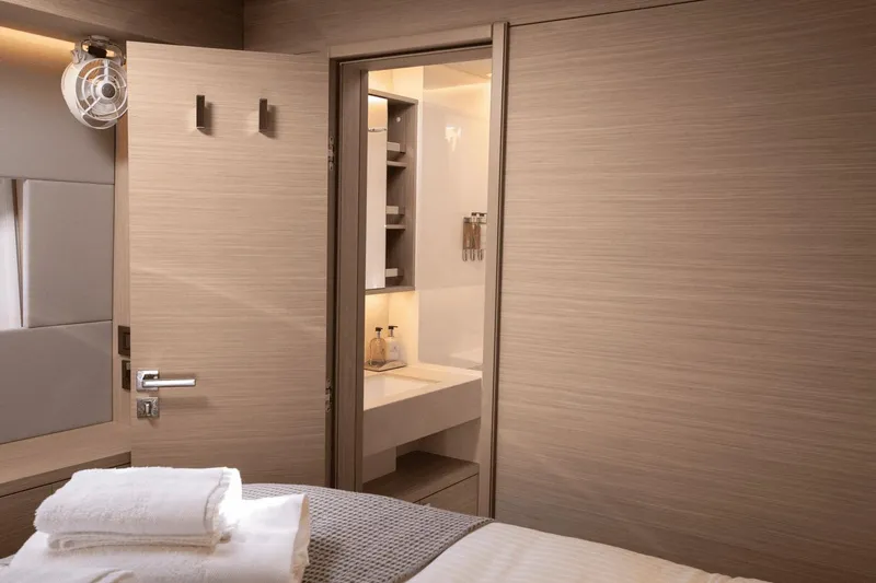  Yacht Photos Pics Luxurious interior of 2025 Lagoon 60 yacht cabin with modern bathroom.