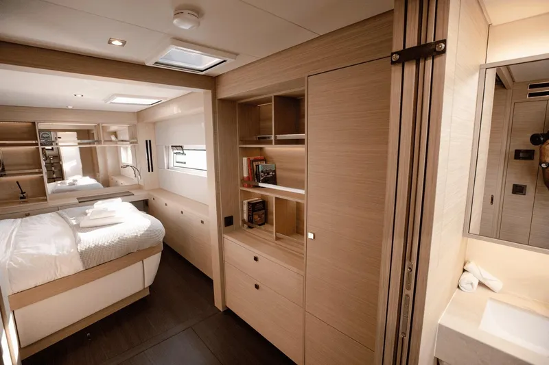  Yacht Photos Pics Luxurious interior of 2025 Lagoon 60 yacht with modern bedroom and bathroom design.