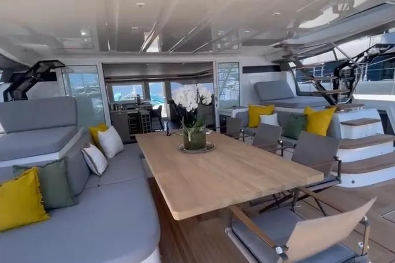  Yacht Photos Pics Luxurious interior of 2025 Lagoon 60 yacht with elegant seating and dining area.