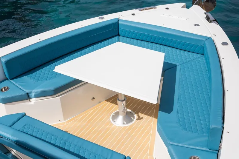  Yacht Photos Pics Luxurious seating area on 2026 De Antonio Yachts D29 with turquoise cushions and white table.