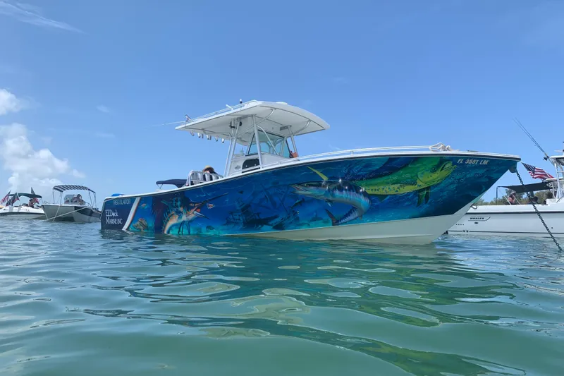  Yacht Photos Pics 2001 Regulator 32 Center Console boat with vibrant marine-themed hull design on the water.