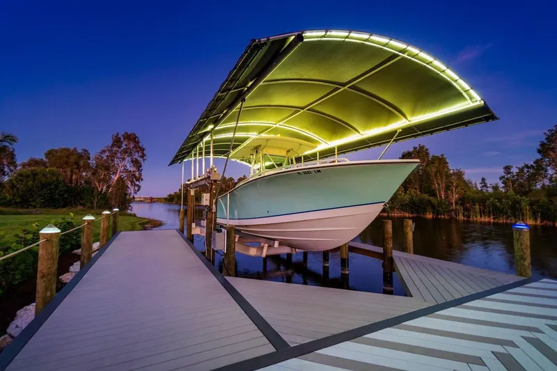  Yacht Photos Pics 2001 Regulator 32 Center Console boat docked under illuminated canopy at sunset.