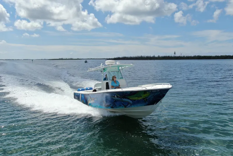  Yacht Photos Pics 2001 Regulator 32 Center Console boat cruising on open water under a blue sky.