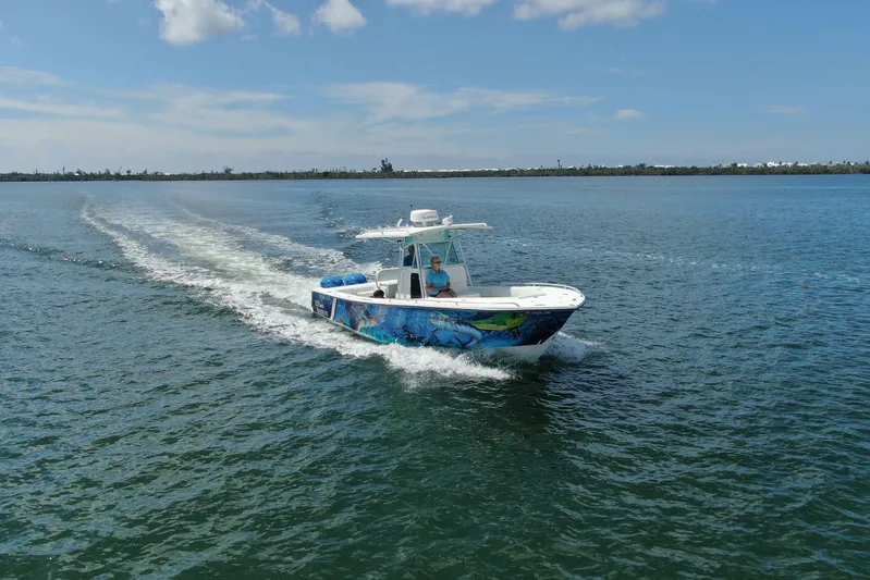  Yacht Photos Pics 2001 Regulator 32 Center Console boat cruising on open water under a clear sky.