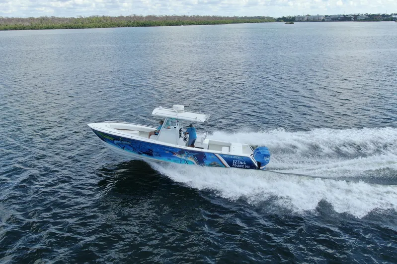  Yacht Photos Pics 2001 Regulator 32 Center Console boat cruising on open water.