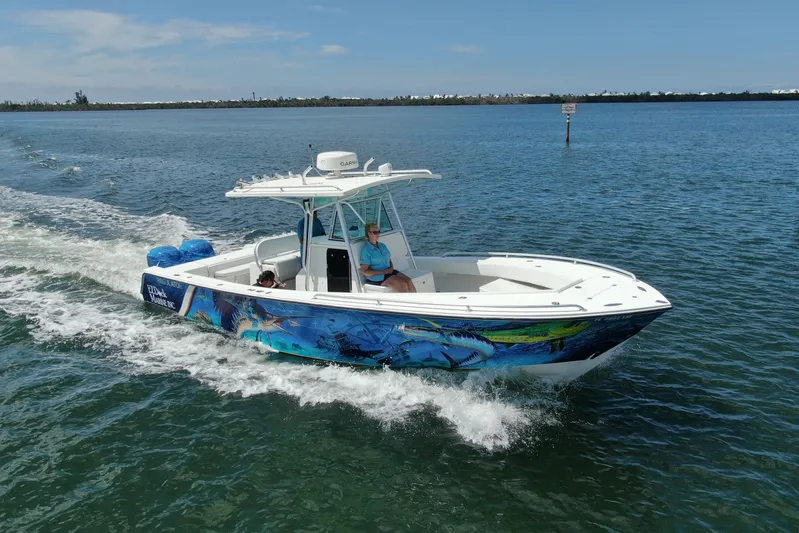  Yacht Photos Pics 2001 Regulator 32 Center Console boat cruising on open water with vibrant marine graphics.