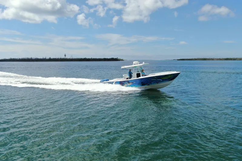  Yacht Photos Pics 2001 Regulator 32 Center Console boat cruising on open water under a clear sky.