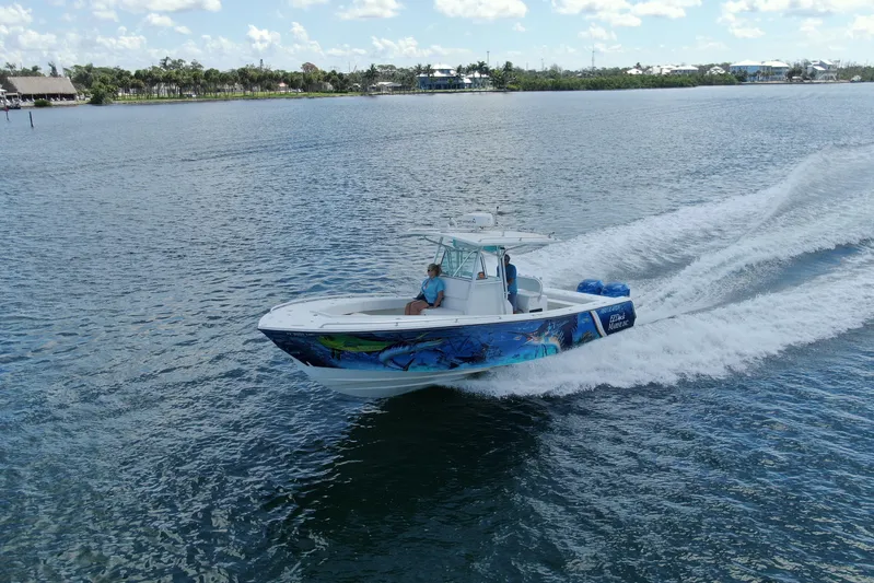  Yacht Photos Pics 2001 Regulator 32 Center Console boat cruising on a sunny day.