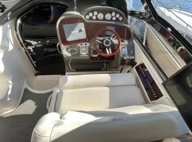  Yacht Photos Pics 2008 Regal 4060 COMMODORE yacht cockpit with steering wheel and control panel.