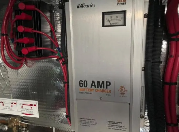  Yacht Photos Pics 60 AMP battery charger in 2008 Regal 4060 COMMODORE engine room, featuring red cables and metallic finish.