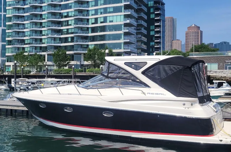  Yacht Photos Pics 2008 Regal 4060 COMMODORE yacht docked near modern city buildings.