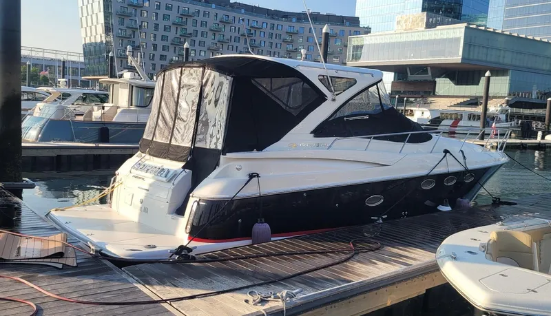  Yacht Photos Pics 2008 Regal 4060 COMMODORE yacht docked at a marina with modern buildings in the background.