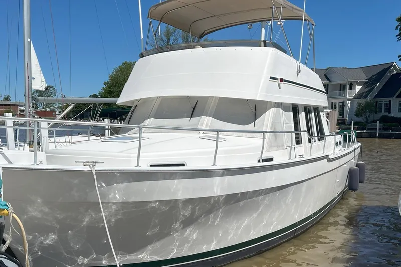 Knot Done Yet Yacht Photos Pics 2002 Mainship 430 Trawler docked, featuring a white exterior and spacious deck.