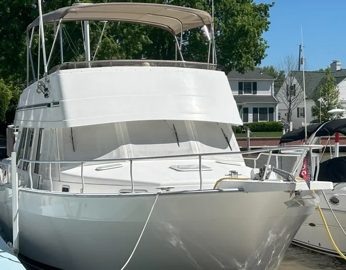 Knot Done Yet Yacht Photos Pics 2002 Mainship 430 Trawler docked at marina, featuring a spacious deck and canopy.