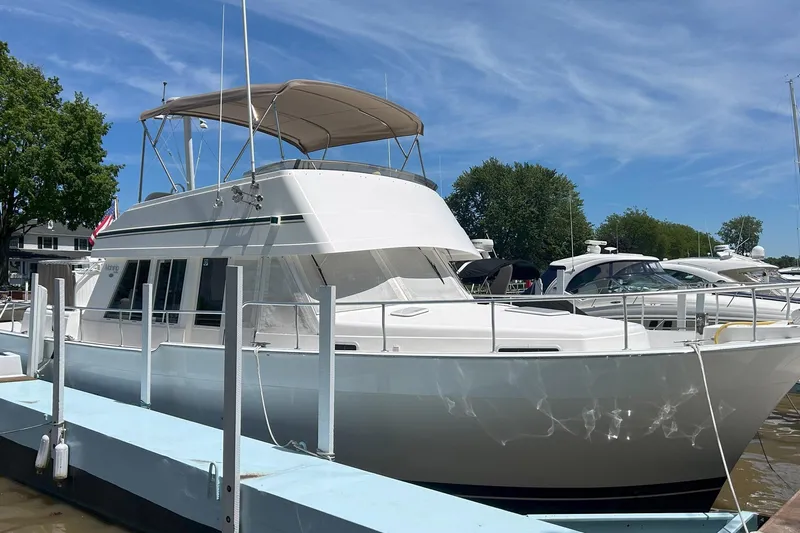 Knot Done Yet Yacht Photos Pics 2002 Mainship 430 Trawler docked at marina under clear blue sky.