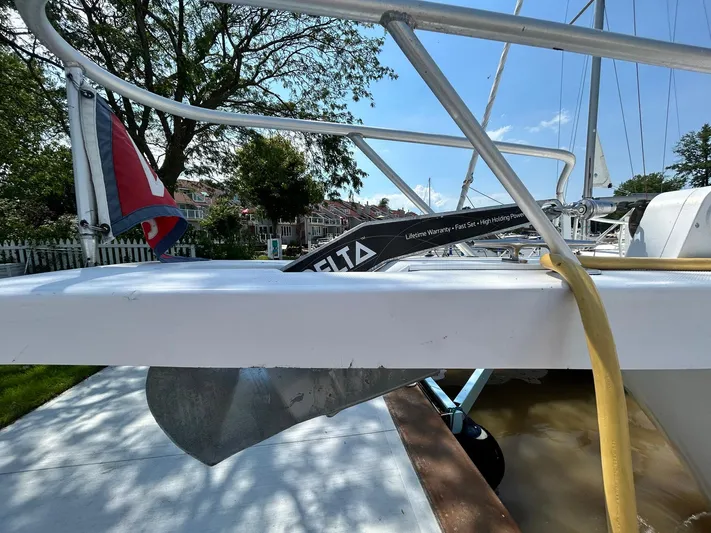 Knot Done Yet Yacht Photos Pics 2002 Mainship 430 Trawler with Delta anchor, docked near residential area.