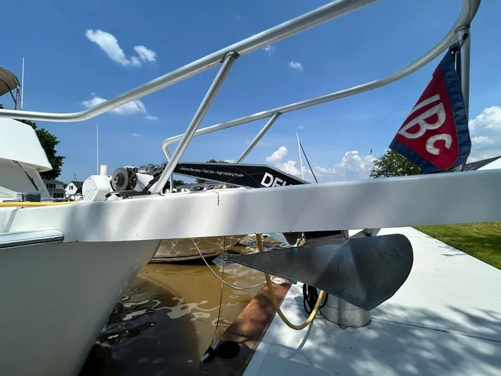 Knot Done Yet Yacht Photos Pics 2002 Mainship 430 Trawler docked, showcasing anchor and railing under a clear blue sky.