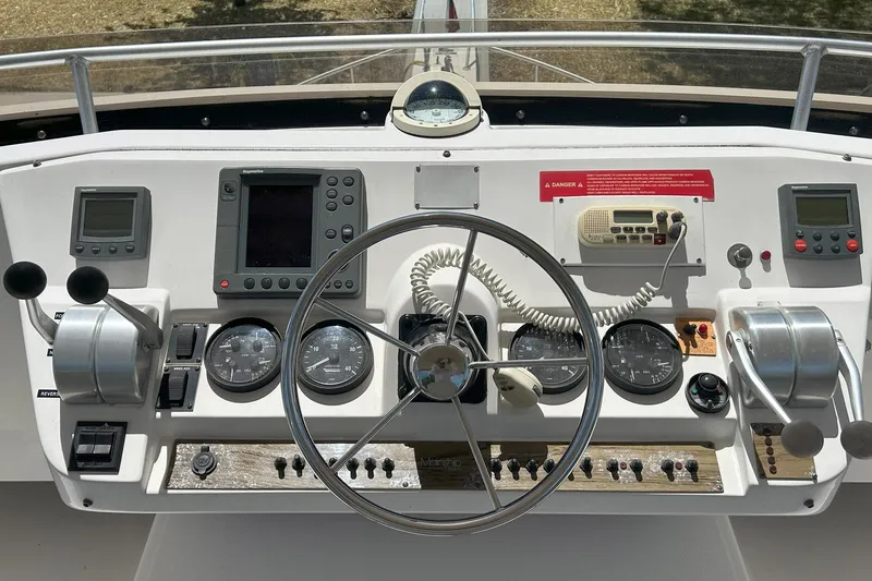 Knot Done Yet Yacht Photos Pics 2002 Mainship 430 Trawler helm with navigation instruments and steering wheel.