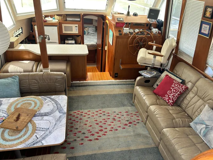 Knot Done Yet Yacht Photos Pics Interior of 2002 Mainship 430 Trawler with cozy seating and nautical decor.