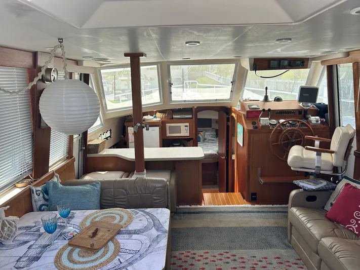 Knot Done Yet Yacht Photos Pics Interior of 2002 Mainship 430 Trawler with cozy seating and nautical decor.