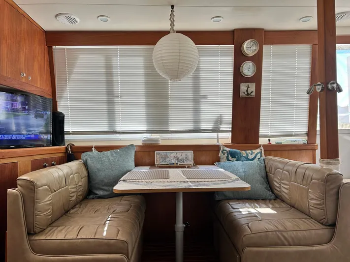 Knot Done Yet Yacht Photos Pics Interior of 2002 Mainship 430 Trawler with cozy dining area and nautical decor.