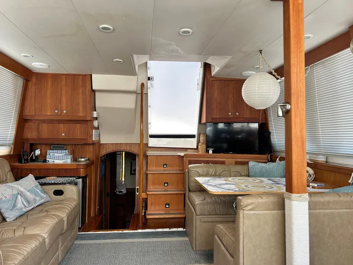 Knot Done Yet Yacht Photos Pics Interior of 2002 Mainship 430 Trawler with wood cabinetry, leather seating, and modern amenities.