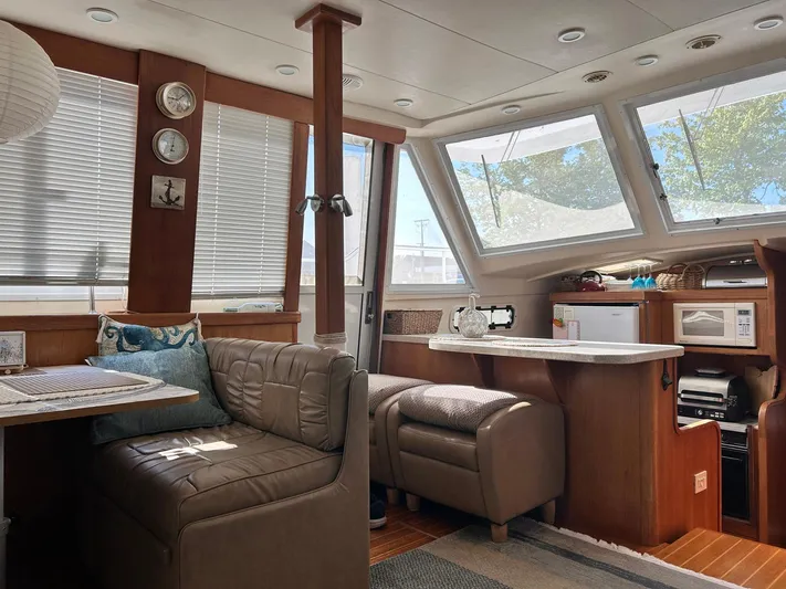 Knot Done Yet Yacht Photos Pics Interior of 2002 Mainship 430 Trawler with cozy seating and modern kitchen amenities.