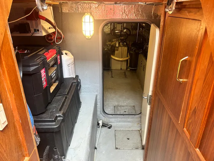 Knot Done Yet Yacht Photos Pics Engine room of 2002 Mainship 430 Trawler with toolboxes and wooden cabinetry.
