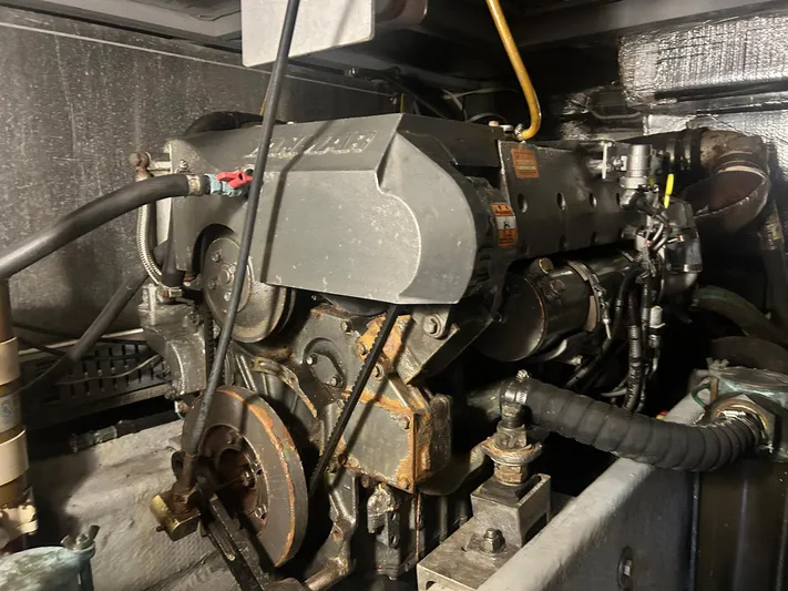 Knot Done Yet Yacht Photos Pics Engine of a 2002 Mainship 430 Trawler, showcasing mechanical components and hoses.