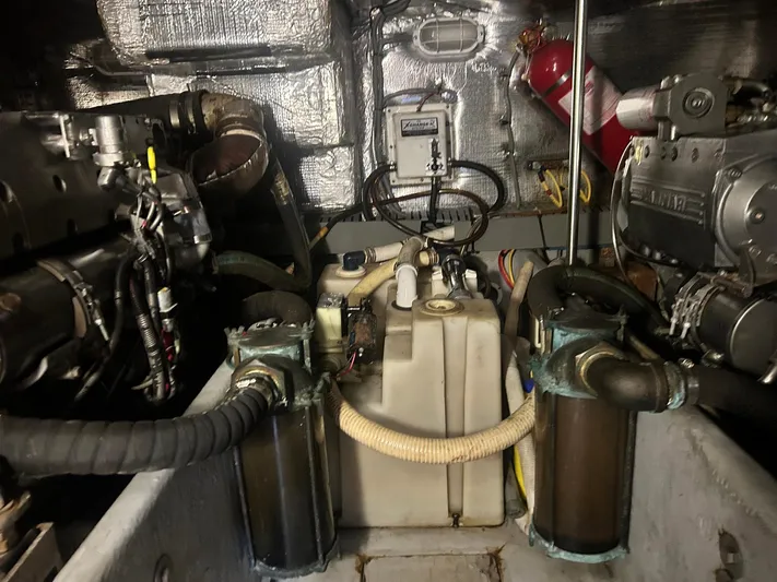 Knot Done Yet Yacht Photos Pics Engine room of a 2002 Mainship 430 Trawler with visible machinery and components.