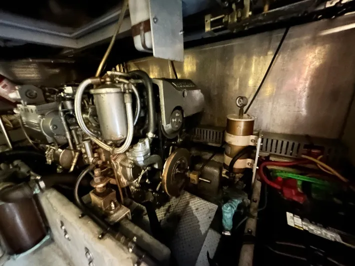 Knot Done Yet Yacht Photos Pics Engine room of a 2002 Mainship 430 Trawler, showcasing mechanical components and wiring.