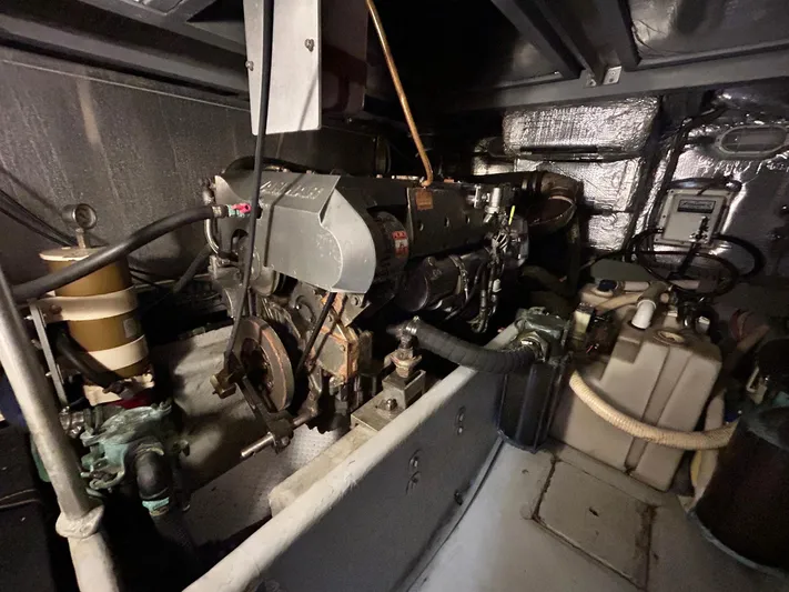 Knot Done Yet Yacht Photos Pics Engine room of a 2002 Mainship 430 Trawler, showcasing mechanical components and equipment.