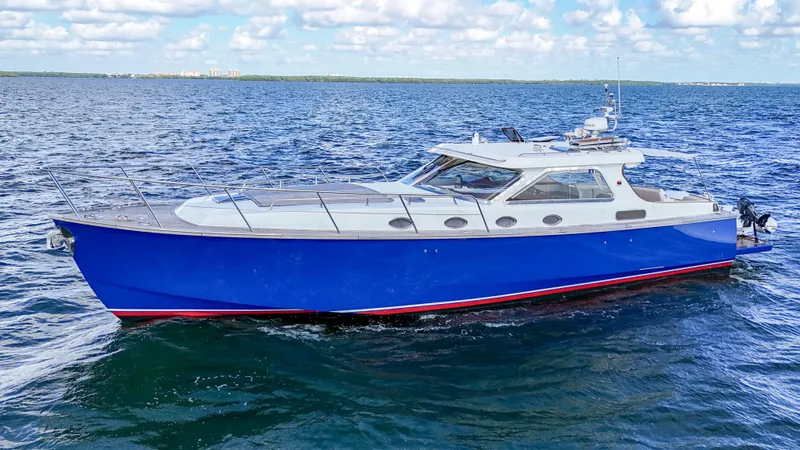 Noi Qauttro Yacht Photos Pics Custom 48 yacht, 2010 model, cruising on open water under a partly cloudy sky.