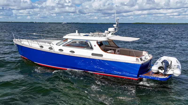 Noi Qauttro Yacht Photos Pics Custom 48 yacht, 2010 model, cruising on open water under a partly cloudy sky.