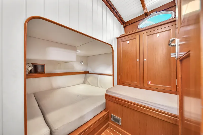 Noi Qauttro Yacht Photos Pics Cozy cabin interior of a 2010 Custom 48 yacht with wooden finishes and comfortable bedding.
