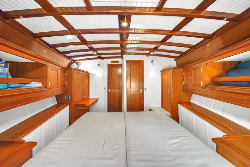 Noi Qauttro Yacht Photos Pics Luxurious wooden interior of a 2010 Custom 48 yacht cabin with twin beds.