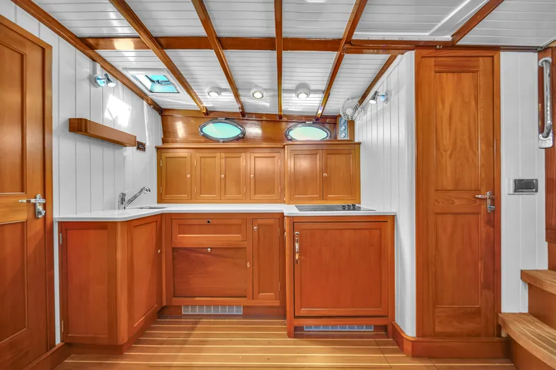 Noi Qauttro Yacht Photos Pics Wooden boat interior with cabinets, porthole windows, and modern fixtures, Custom 48 model, 2010.