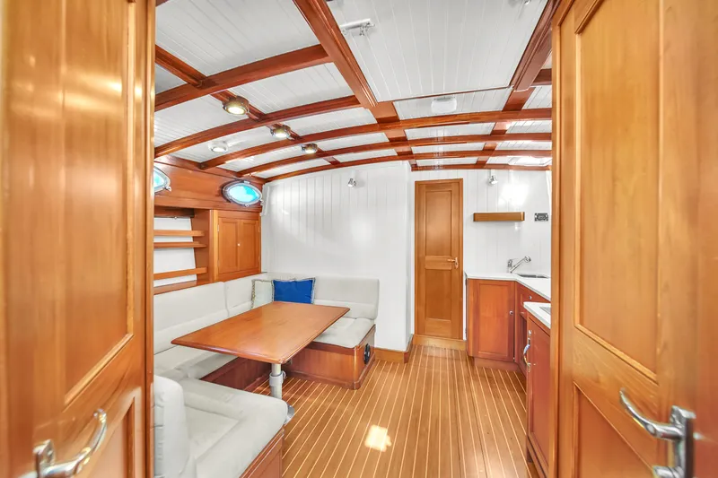 Noi Qauttro Yacht Photos Pics Luxurious wooden yacht interior with seating area and kitchenette, Custom 48 model, 2010.
