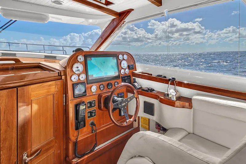 Noi Qauttro Yacht Photos Pics Luxurious yacht helm with wooden dashboard, ocean view, and modern navigation equipment. Custom model 48, 2010.