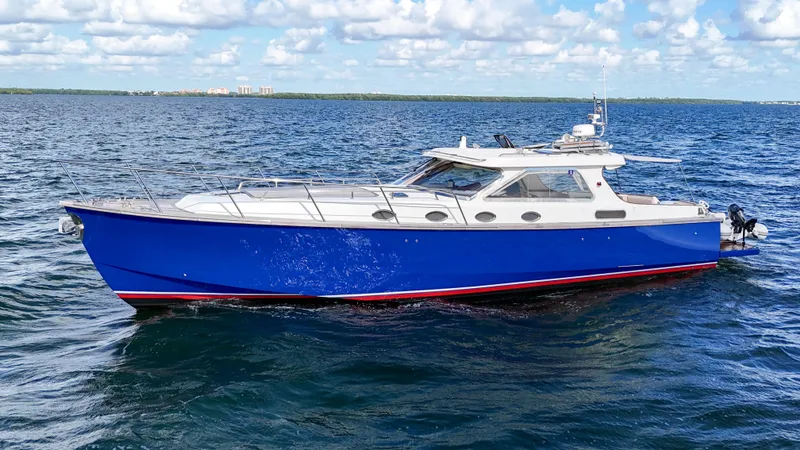 Noi Qauttro Yacht Photos Pics Custom 48 yacht, 2010 model, cruising on open water under a partly cloudy sky.