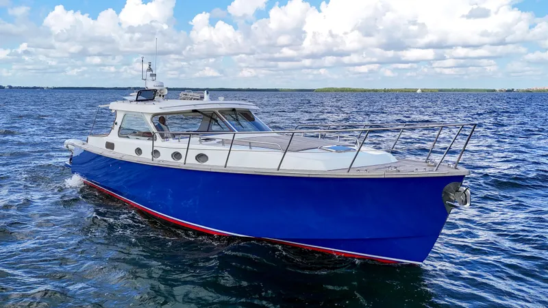 Noi Qauttro Yacht Photos Pics Custom 48 boat from 2010 cruising on open water under a cloudy sky.